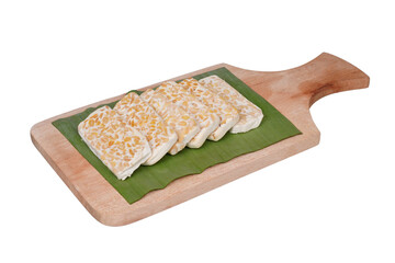 Slices of raw tempeh on a wooden cutting board isolated transparent