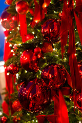 christmas tree with red toy balls, lights bokeh in the background, merry christmas, shallow depth of field, New Year's decor