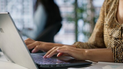 Confident skilled entrepreneur seated at her corporate office desk, is deep in her thoughts using...