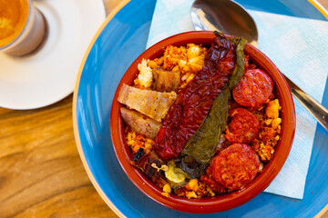 Traditional Spanish dish, migas, served on table in bowl.