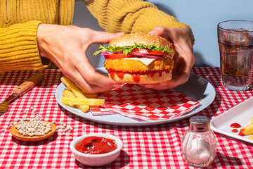 Enjoying a Tasty Chicken Burger with Fries and Beverage