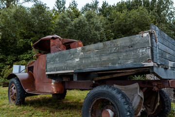 Rusty vintage truck abandoned in grassy field