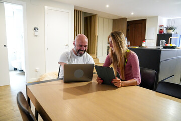 Disability man enjoying technology with a friend at home