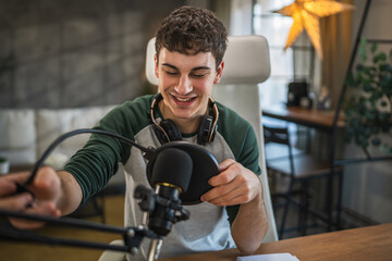 Young man blogger prepare equipment for new video at home studio