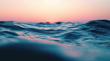 A serene ocean view at dusk, showcasing gentle waves and a colorful horizon blending soft pinks and blues.