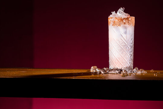 Elegant Paloma Cocktail with Salted Rim and Ice on Table