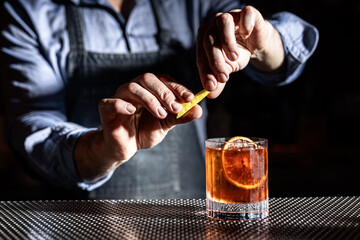 Bartender Garnishing an Elegant Whiskey Old Fashioned Cocktail