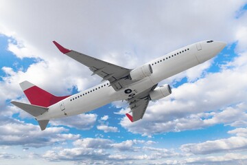 Airplane flying in blue cloudy sky, travel background