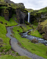 Path and river leading to waterfall in Iceland