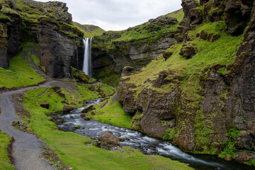 Path and river leading to waterfall in Iceland