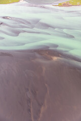 Fototapeta premium Glacial River in Iceland from above, top view, beautiful glacial runoff, mineral river