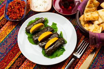 Turkish dish Yaprak sarma, stuffed with rice and spices on a white plate