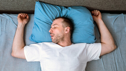 Man Sleeping Alone And Snoring Lying In Bed Staying At Home During Social Distancing Quarantine. Above View