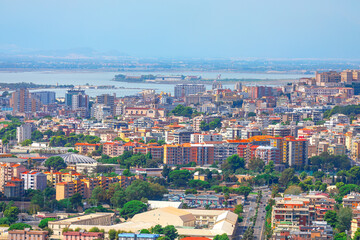 Naklejka premium Aerial panoramic view of Cagliari city in Sardinia, Italy. Vibrant city skyline featuring numerous buildings alongside sea