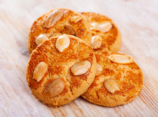 Round shortbread almond biscuits on wooden surface. Tasty dessert