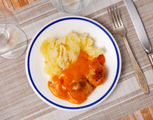 Delicious meatballs served in sauce with mashed potatoes on plate