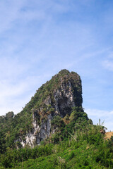 A rock formation against a blue summer sky