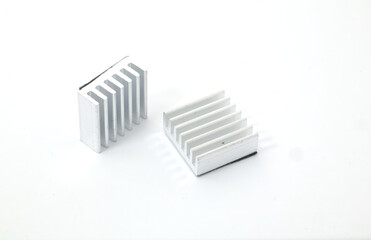 Front view of 2 aluminum heat sinks on a white background. Component part of electronic or computer work.