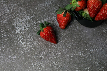 Fresh Strawberries on dark background. Summer red fruit with Copy space for text. Organic healthy eating.