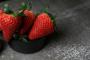 Fresh Strawberries on dark background. Summer red fruit with Copy space for text. Organic healthy eating.