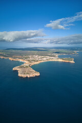 View of Sagres coastline, town and beaches from the ocean. Sagres Fortress is in the foreground