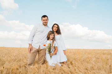 happy family in cereal field at sunset