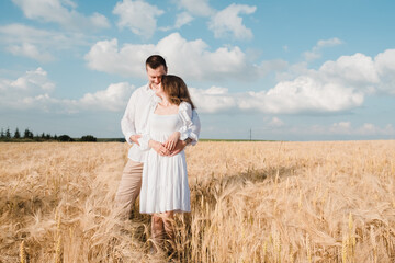 Romantic young couple standing in wheat field,Man and woman in wheat two