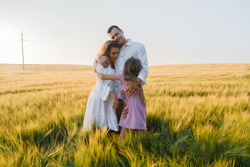 Love and happiness family together in wheat field.