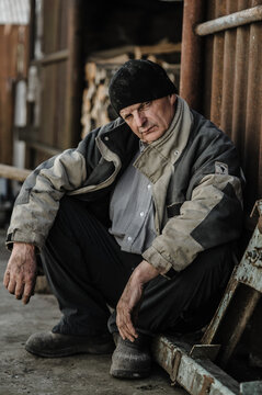 The cinematic lighting creates a powerful emotional atmosphere.He is wearing a dark winter jacket and casual clothes.This authentic retro portrait tells a compelling life story.