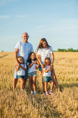 Mother and daughter hug in a wheat field.Cute beautiful children.Family vacation.
Cheerful children picnicking in the park.Mom and daughter in wheat photoset, holidays, recovery.