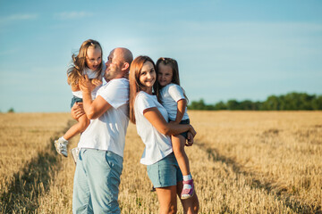 Happy cheerful family has a day off.Family, and nature with flowers, field and trees for bonding, love and social media together outdoor. Woman, kid and man playing at park in summer for happy.