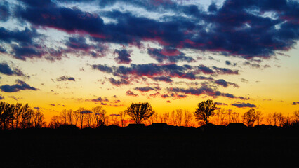 Dramatic cloudscape over the meadow forest at autumn sunset in the suburb of Indianapolis, Indiana