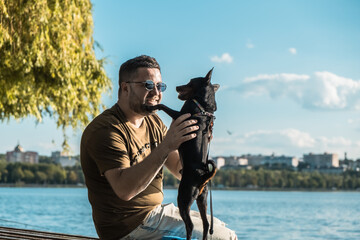 The dog jumps up to the owner.A funny dog stands on its hind legs.