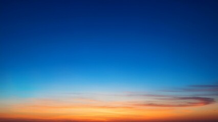 Obraz premium Beautiful sky gradient transitioning from deep blue to warm orange at sunset 