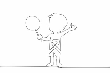 Single one line drawing a little boy holding lollipop stands with arms outstretched. Innocence. Imagination. Survivor. International Childhood Cancer Day. Continuous line design graphic illustration