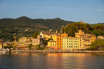 Fototapeta premium Early morning sun warming the buildings in the Italian harbor of Santa Margherita.