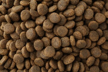Pet food granules as background, top view