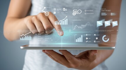 Person Holding Tablet Displaying Business Data Visualizations and Charts