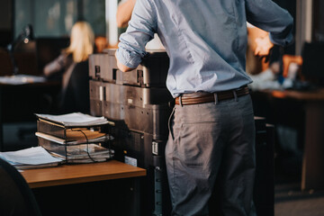 Close up of man in the office printing paper