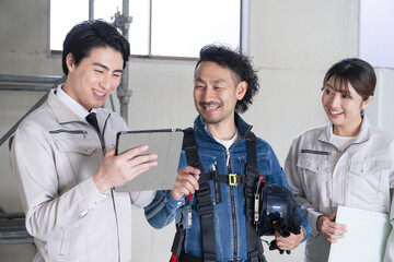 General contractor types in work clothes and site supervisors in denim Talking as a team, checking...