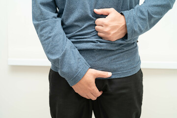Fototapeta premium Hernia, Asian man stomach ache, abdominal pain and urology problem health.