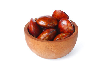 Dogfruit (Archidendron pauciflorum) an Indonesia commonly called djenkol, jengkol or jering on a small wooden bowl isolated on white background. Food Ingredients