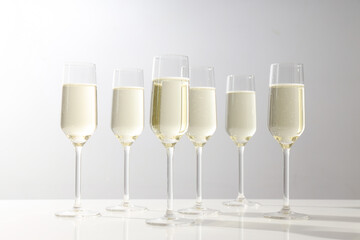Glasses of champagne on a light background