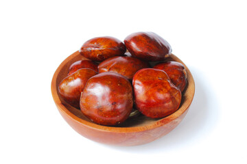 Obraz premium Dogfruit (Archidendron pauciflorum) an Indonesia commonly called djenkol, jengkol or jering on a small wooden plate isolated on white background. Food Ingredients