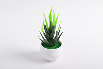 Artificial plant in white pot isolated on white background.
