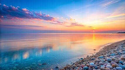 Obraz premium Serene Sunset Over a Coastal Landscape with a Pebble Beach and Soft, Colorful Clouds