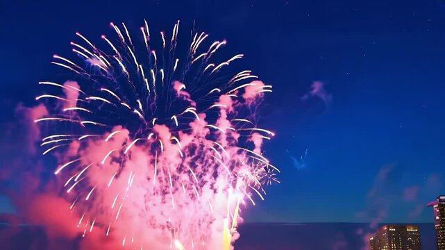 A dazzling display fireworks bursts night sky bright sparks smoke effects creating festive celebratory atmosphere ideal New Year&rsquo;s Eve Independence Day any holiday event celebration blue explosion