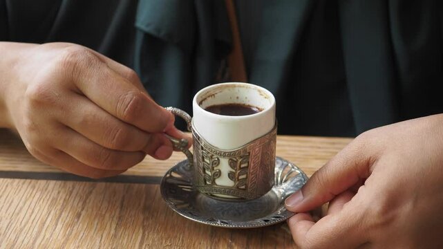 woman drinking turkish coffee at cafe 
