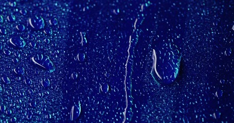 Wet surface. Blue droplet. Fresh raindrops spill on glossy smooth area. Rainy weather moistening humidity washing top water texture.