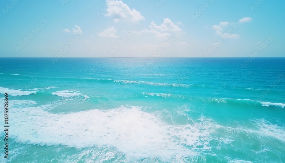 Poster a serene ocean view featuring crystal-clear waters and soft waves under a bright blue sky with scatt